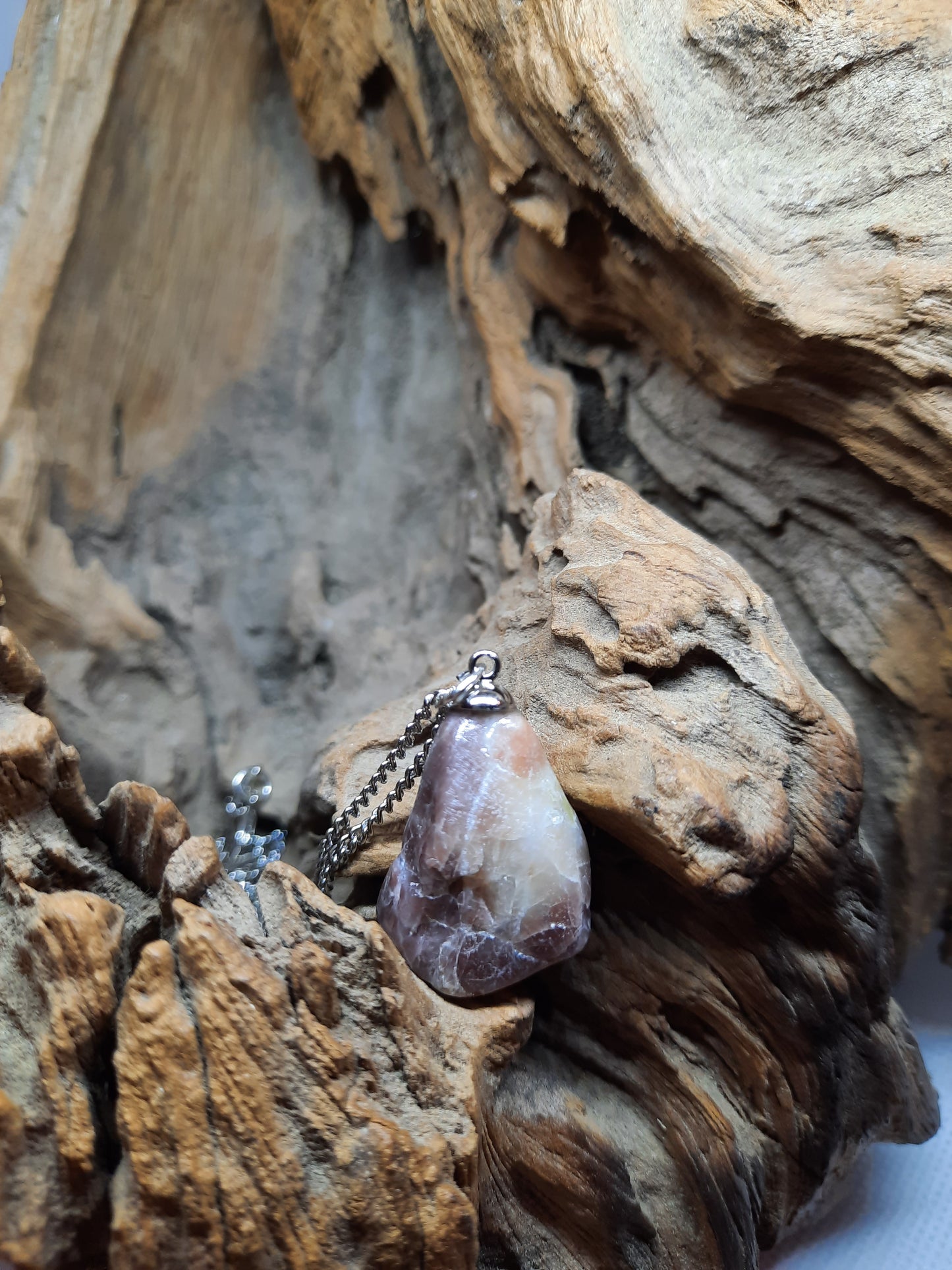 Silver colored necklace with brown natural stone