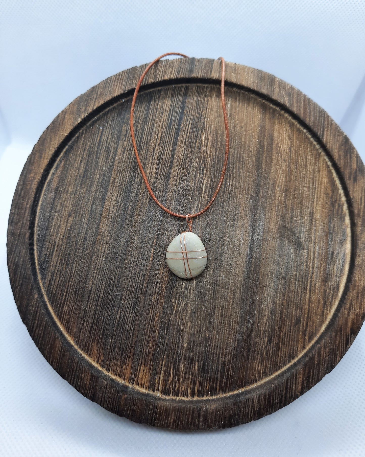 Brown leather necklace with a gray natural stone pendant