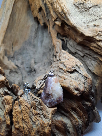 Silver colored necklace with brown natural stone